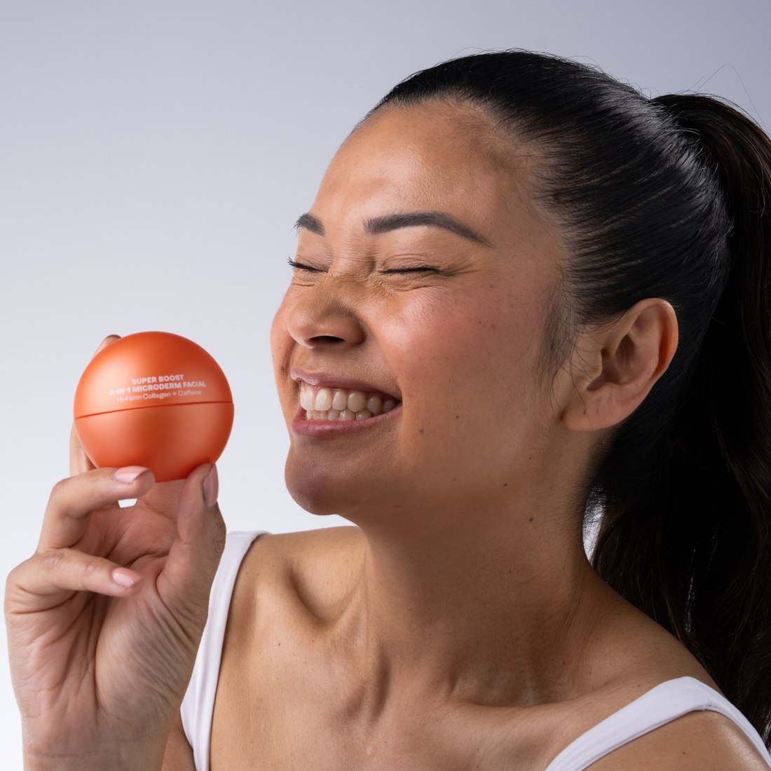 Woman applying Super Boost Microderm Facial - at-home salon treatment